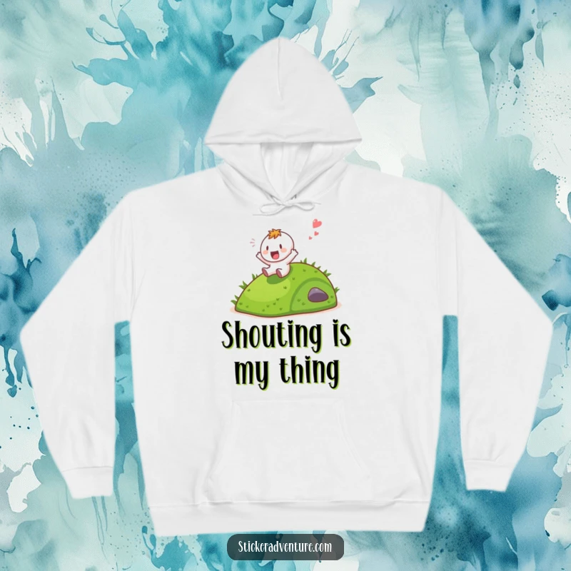 A cozy hoodie featuring a funny character sliding down a grassy hill with a gleeful shout.
