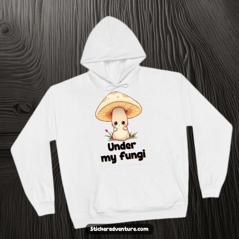Funny hoodie featuring a tiny character peeking out with curious eyes from behind a large mushroom, embodying playful mystery.